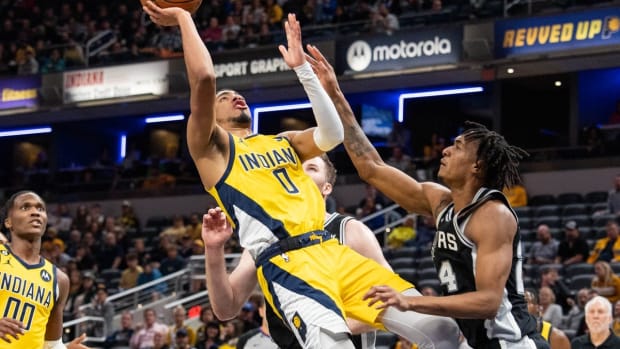 Oct 21, 2022; Indianapolis, Indiana, USA; Indiana Pacers guard Tyrese Haliburton (0) shoots the ball over San Antonio Spurs guard Devin Vassell (24) in the second half at Gainbridge Fieldhouse. Mandatory Credit: Trevor Ruszkowski-USA TODAY Sports